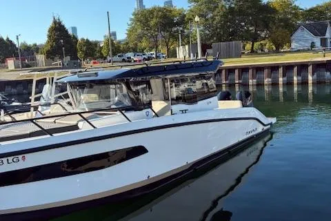 Slide: The Image of 2025 Navan C30 boat docked in a marina, surrounded by trees and buildings. - 20