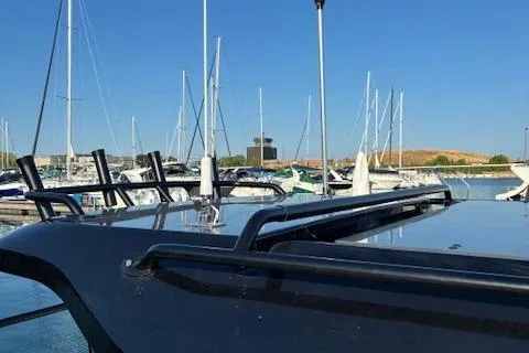 Slide: The Image of Modern Navan C30 boat docked at marina, surrounded by sailboats, under clear blue sky. - 25