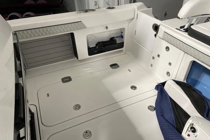 Slide: The Image of 2025 Blackfin 400 CC boat interior with storage compartments and seating. - 13