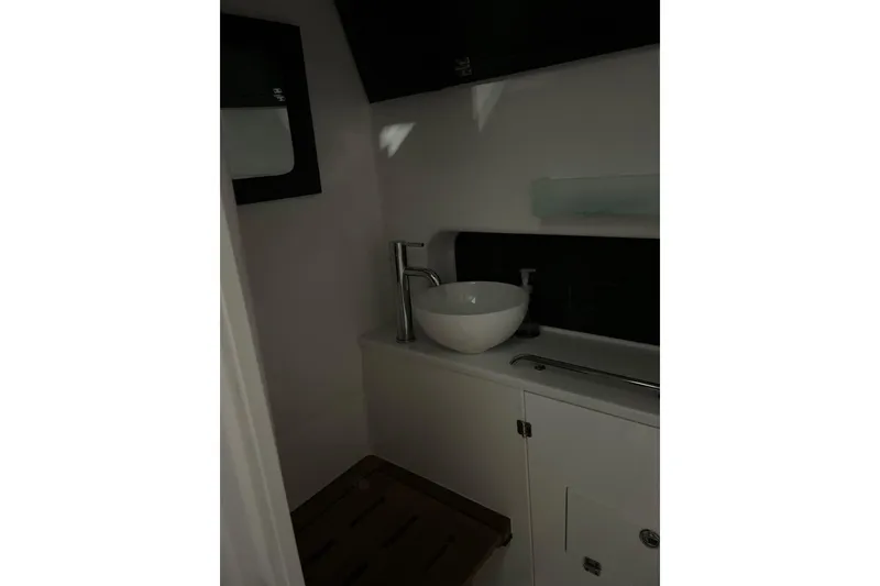 Slide: The Image of 2025 Blackfin 400 CC boat interior with modern sink and sleek cabinetry. - 14