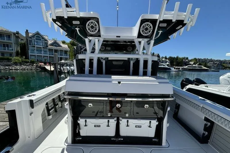Slide: The Image of 2025 Blackfin 400 CC boat with Yeti coolers, docked at a marina. - 17