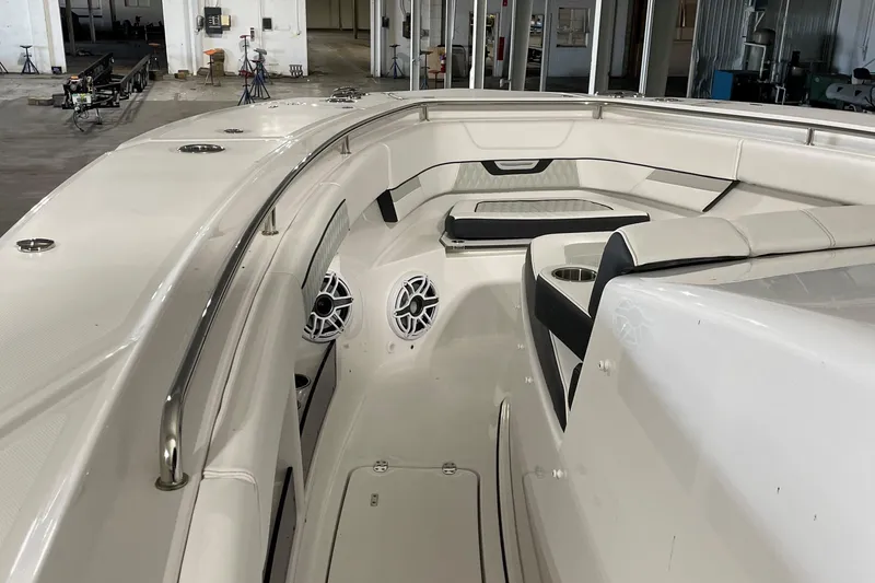 Slide: The Image of 2025 Blackfin 400 CC boat interior with seating and speakers in a warehouse setting. - 19