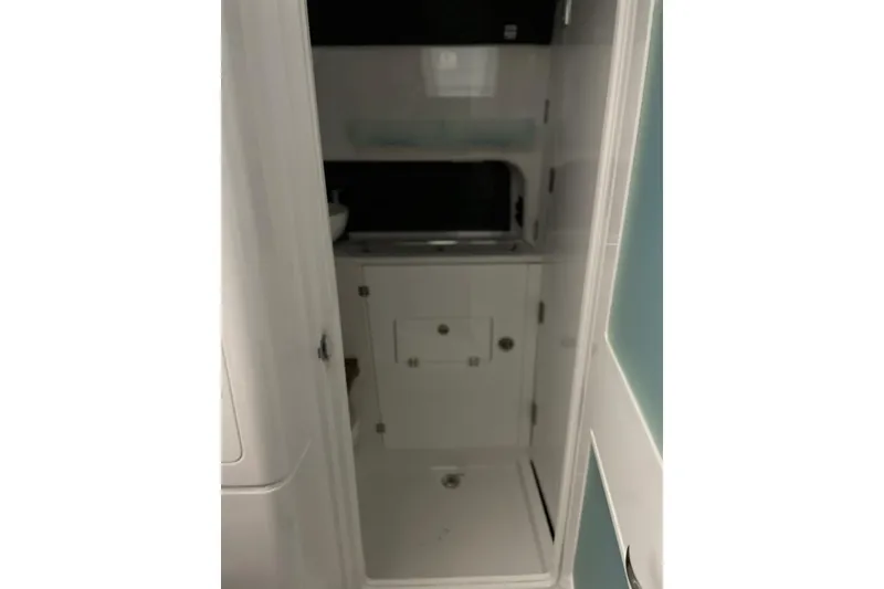 Slide: The Image of Interior of 2025 Blackfin 400 CC boat, featuring compact bathroom space. - 23