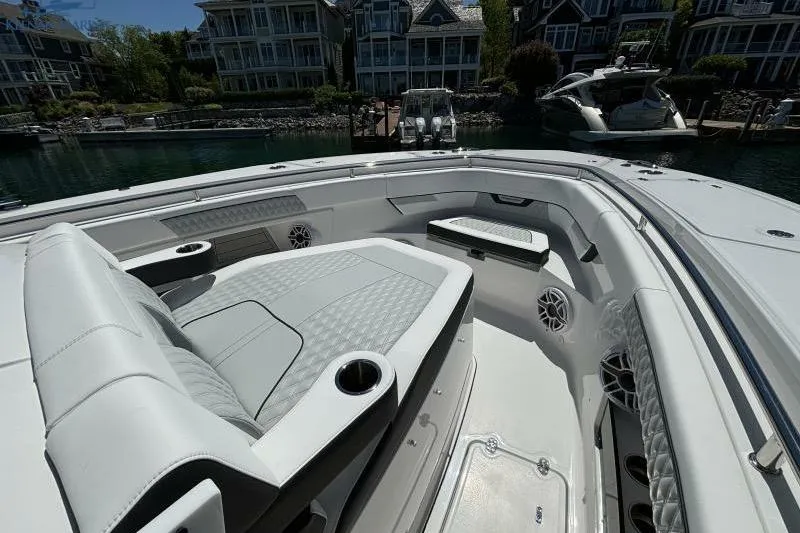 Slide: The Image of 2025 Blackfin 400 CC boat interior with luxurious seating and waterfront view. - 27
