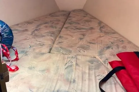 Slide: The Image of Interior cabin of 1995 Catalina 30 Mk III sailboat with patterned bedding. - 10