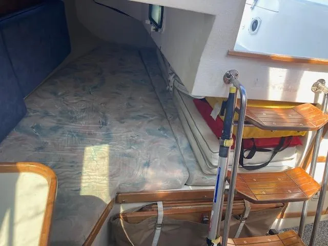 Slide: The Image of Interior cabin of a 1995 Catalina 30 Mk III sailboat with wooden steps. - 11