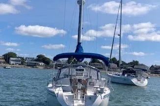 Slide: The Image of Sailboat Catalina 30 Mk III, 1995 model, anchored in a scenic harbor. - 2