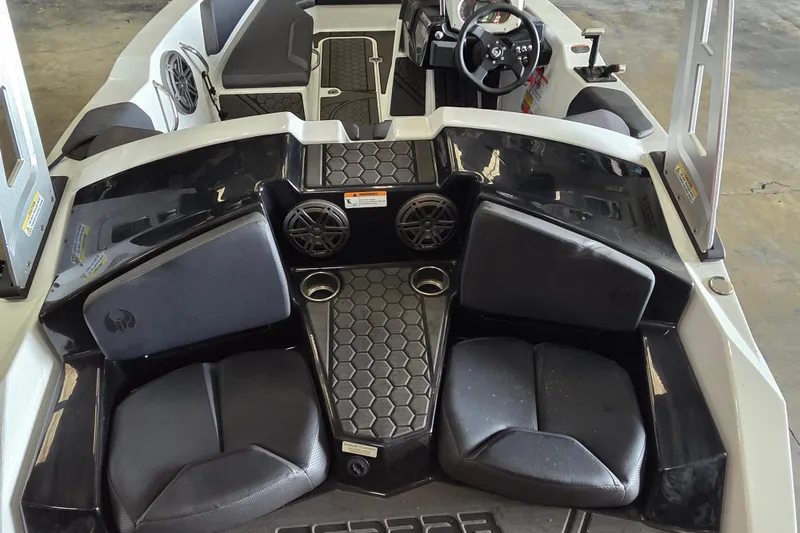 Slide: The Image of 2023 Scarab 165 H.O. Platinum boat in storage, surrounded by other boats. - 11