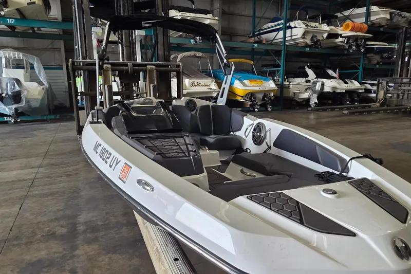 Slide: The Image of 2023 Scarab 165 H.O. Platinum boat interior with seating and steering wheel. - 12