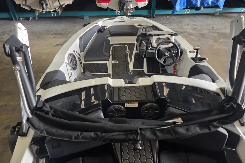 Slide: The Image of 2023 Scarab 165 H.O. Platinum boat in storage facility, surrounded by other boats. - 2