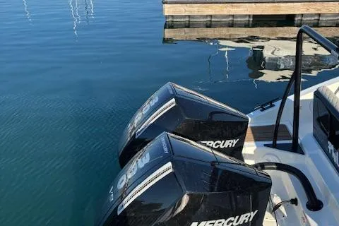 Slide: The Image of Navan C30 2025 boat with dual Mercury outboard engines docked on calm water. - 18