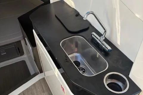 Slide: The Image of 2025 Navan C30 boat kitchenette with sleek black countertop and modern sink design. - 27