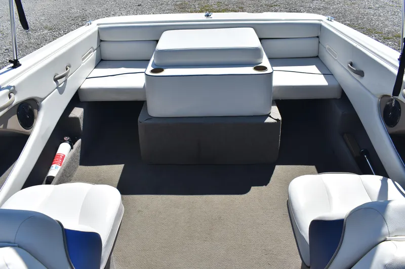 Slide: The Image of 2004 Bayliner 215 Bowrider interior with white seating and carpeted floor. - 9