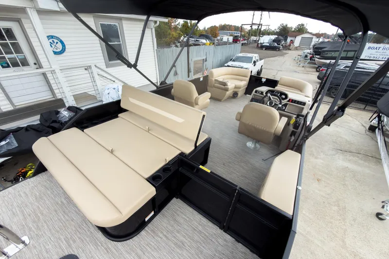 Slide: The Image of 2026 Godfrey Sweetwater Xperience 22' Tritoon with beige seating and modern helm. - 12