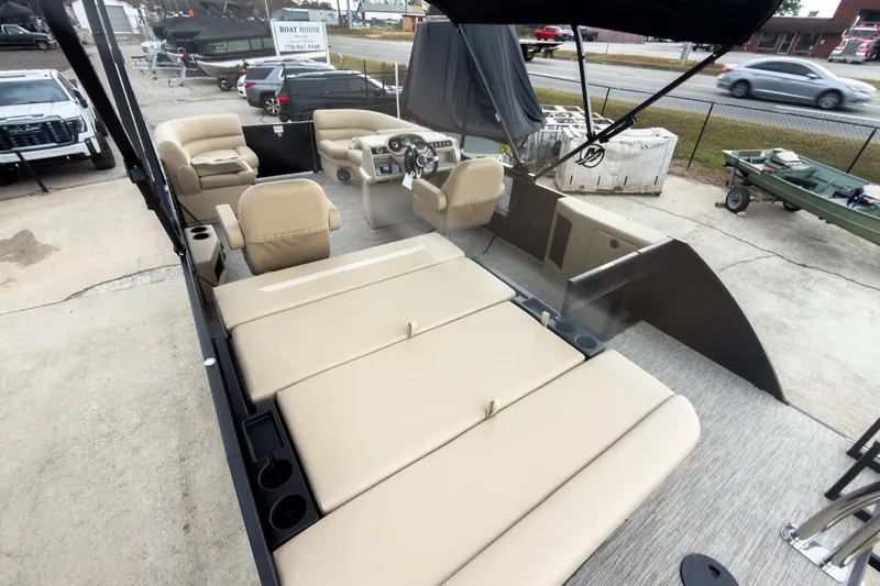 Slide: The Image of 2026 Godfrey Sweetwater Xperience 22' Tritoon with beige seating and modern helm. - 13