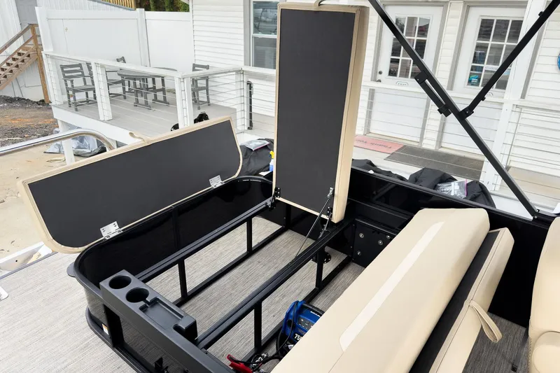 Slide: The Image of 2026 Godfrey Sweetwater Xperience 22' Tritoon with open storage compartments and flip lounge seats. - 19