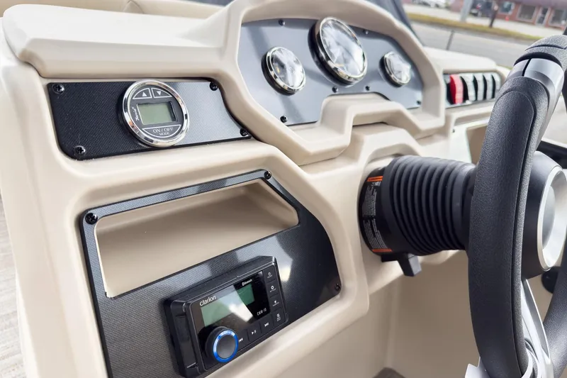 Slide: The Image of Dashboard of 2026 Godfrey Sweetwater Xperience 22' Tritoon with steering wheel and controls. - 24