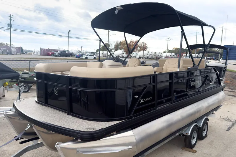 Slide: The Image of 2026 Godfrey Sweetwater Xperience 22' Tritoon with beige seating and black canopy on trailer. - 28