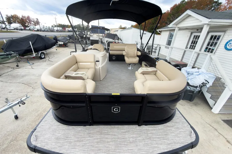 Slide: The Image of 2026 Godfrey Sweetwater Xperience 22' Tritoon with beige seating and black exterior. - 4
