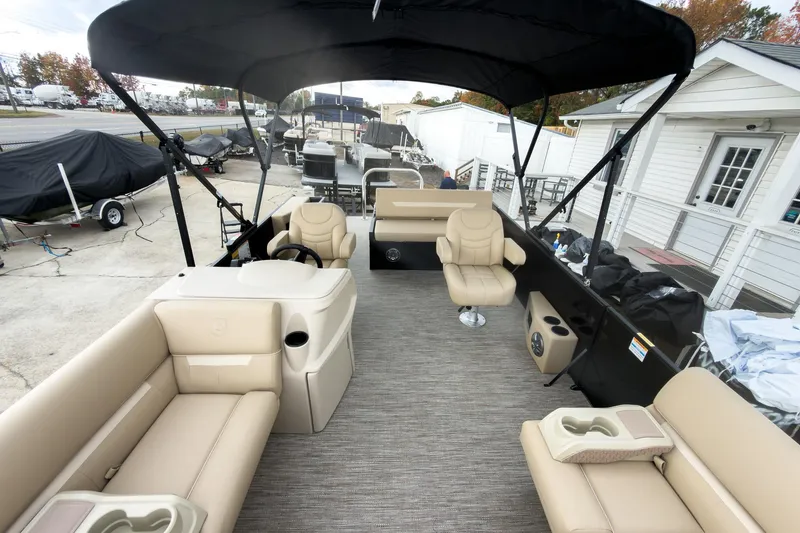 Slide: The Image of 2026 Godfrey Sweetwater Xperience 22' Tritoon with beige seating and black canopy. - 6