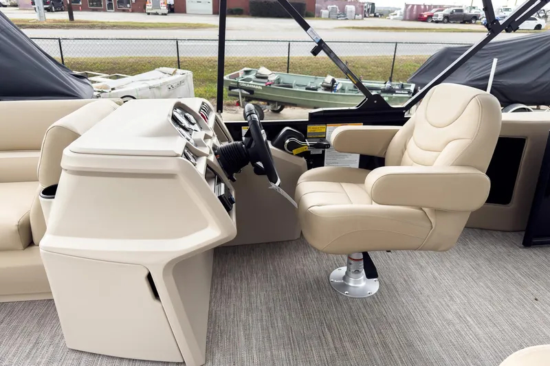 Slide: The Image of 2026 Godfrey Sweetwater Xperience 22' Tritoon helm with beige captain's chair and controls. - 7