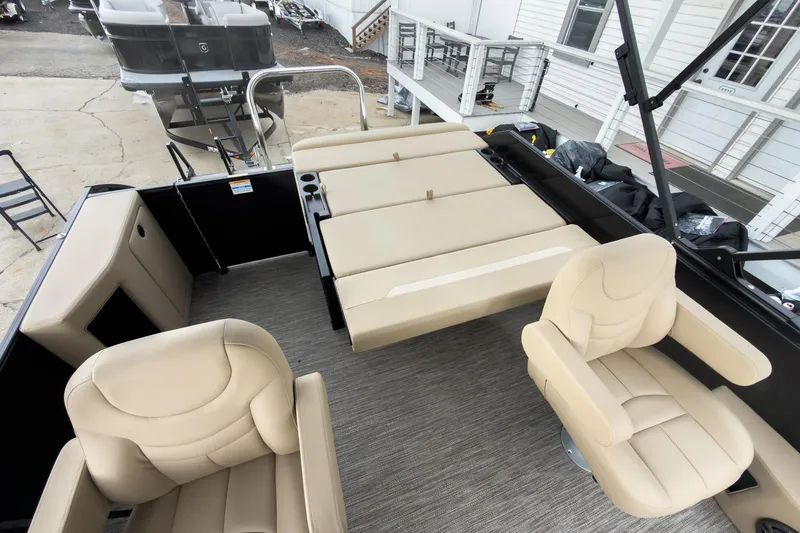 Slide: The Image of 2026 Godfrey Sweetwater Xperience 22' Tritoon interior with beige seating and flip lounge. - 16