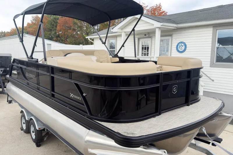 The Image of 2026 Godfrey Sweetwater Xperience 22' Tritoon with beige seating and black exterior, docked. - 2