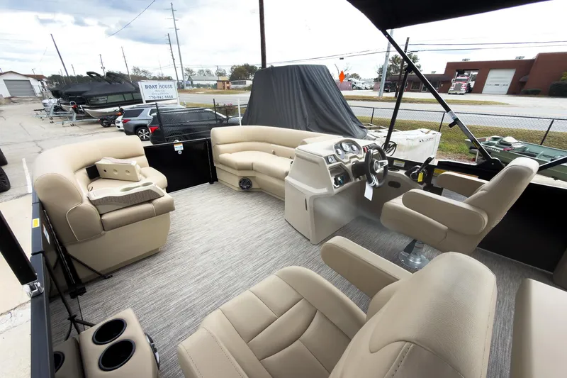 Slide: The Image of Interior of 2026 Godfrey Sweetwater Xperience 22' Tritoon with beige seating and steering console. - 21