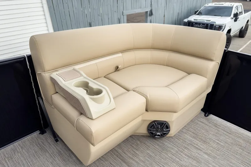 Slide: The Image of Luxurious beige seating on 2026 Godfrey Sweetwater Xperience 22' Tritoon, featuring cup holders and speaker. - 23