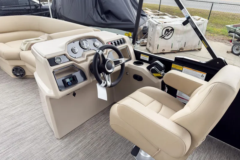 Slide: The Image of 2026 Godfrey Sweetwater Xperience 22' Tritoon helm with beige seating and modern controls. - 8