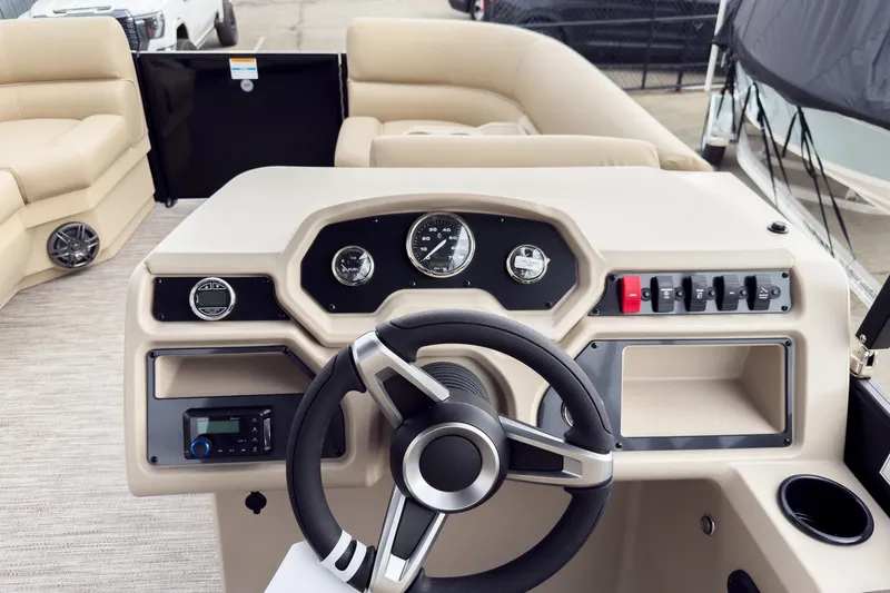 Slide: The Image of 2026 Godfrey Sweetwater Xperience 22' Tritoon dashboard with steering wheel and controls. - 9