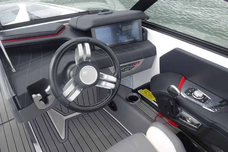 Slide: The Image of 2021 Nautique Super Air Nautique G23 cockpit with modern steering and control panel. - 11