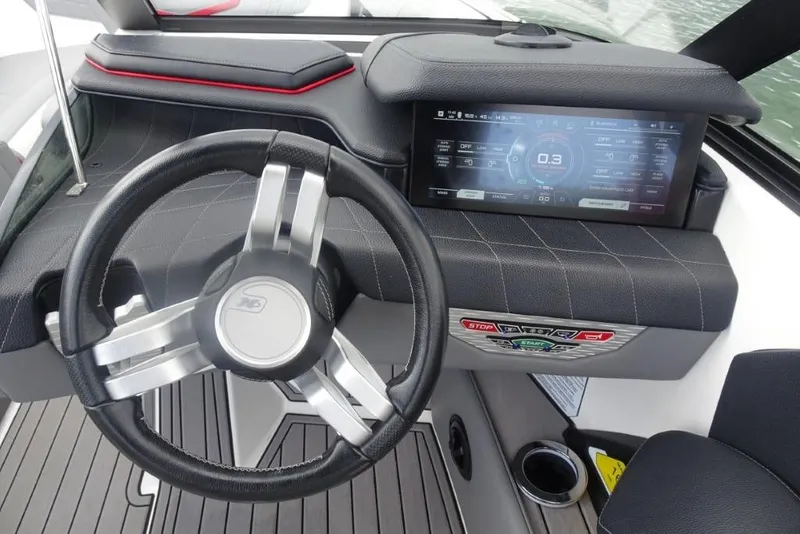 Slide: The Image of 2021 Nautique Super Air Nautique G23 dashboard with steering wheel and digital display. - 12