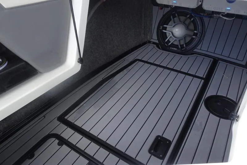 Slide: The Image of 2021 Nautique Super Air Nautique G23 interior with sleek flooring and audio system. - 15