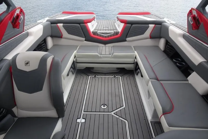 Slide: The Image of 2021 Nautique Super Air Nautique G23 interior with gray and red seating, on water. - 20