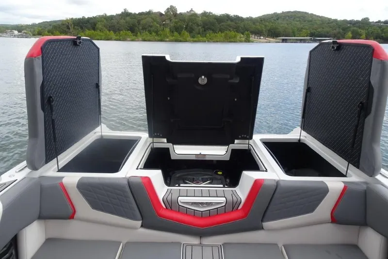 Slide: The Image of 2021 Nautique Super Air Nautique G23 boat storage compartments open on a lake. - 22