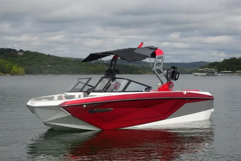 Slide: The Image of 2021 Nautique Super Air Nautique G23 boat on a calm lake with scenic background. - 6
