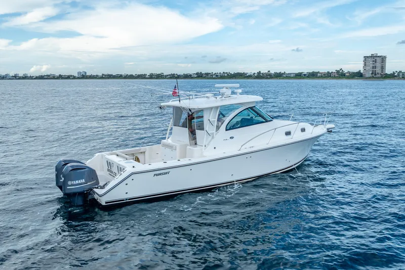 Slide: The Image of 2011 Pursuit OS 345 Offshore boat cruising on open water with Yamaha engines. - 10