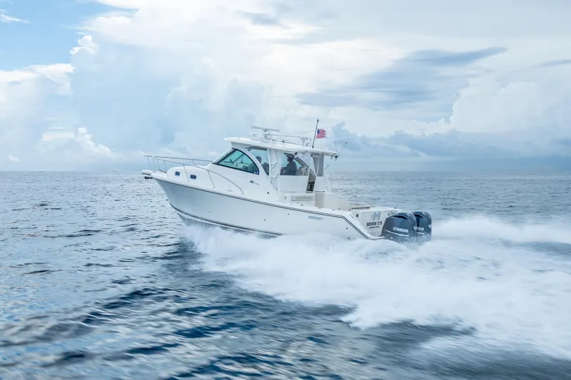 Slide: The Image of 2011 Pursuit OS 345 Offshore boat cruising on open ocean with cloudy sky. - 18