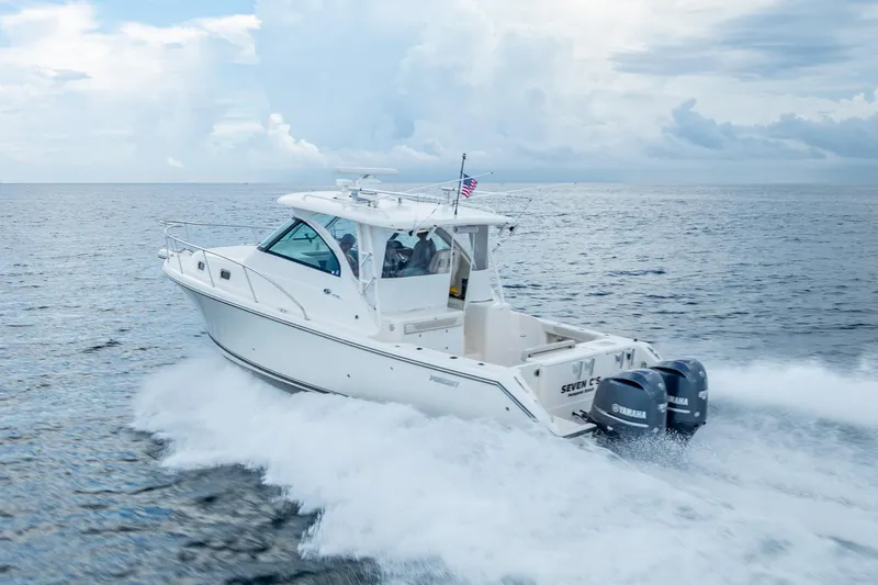 Slide: The Image of 2011 Pursuit OS 345 Offshore boat cruising on open water under cloudy skies. - 19