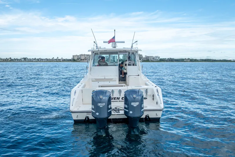 Slide: The Image of 2011 Pursuit OS 345 Offshore boat on open water with twin Yamaha engines. - 3