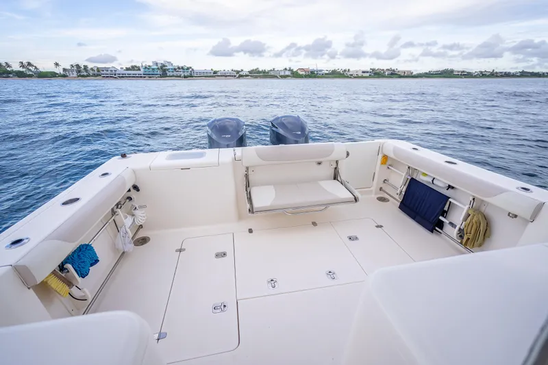 Slide: The Image of 2011 Pursuit OS 345 Offshore boat deck with seating, ocean view, and storage compartments. - 32