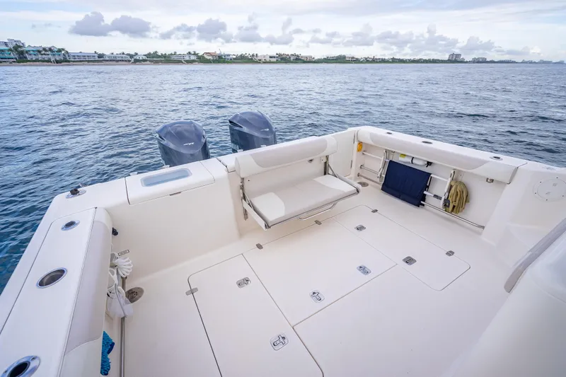 Slide: The Image of 2011 Pursuit OS 345 Offshore boat deck with dual engines, ocean view. - 33