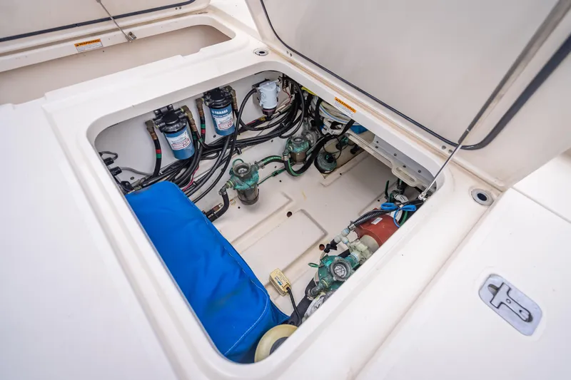 Slide: The Image of 2011 Pursuit OS 345 Offshore engine compartment with Yamaha filters and wiring. - 37