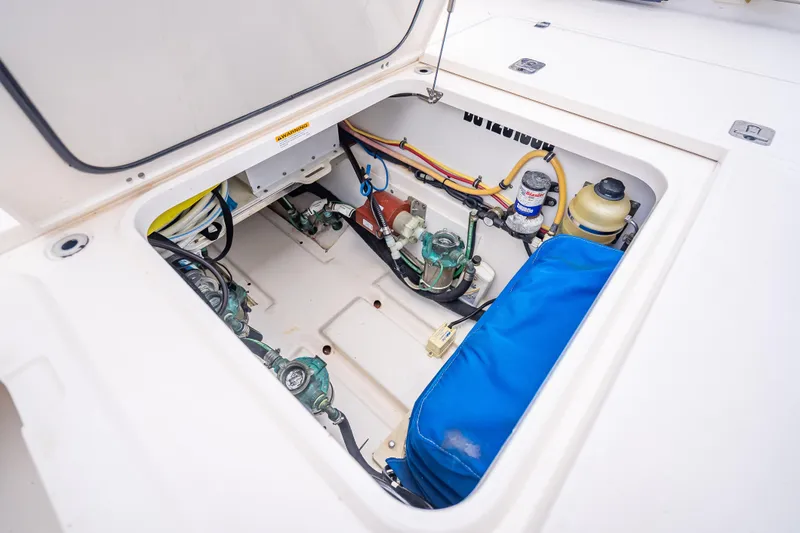 Slide: The Image of 2011 Pursuit OS 345 Offshore engine compartment with visible wiring and components. - 38