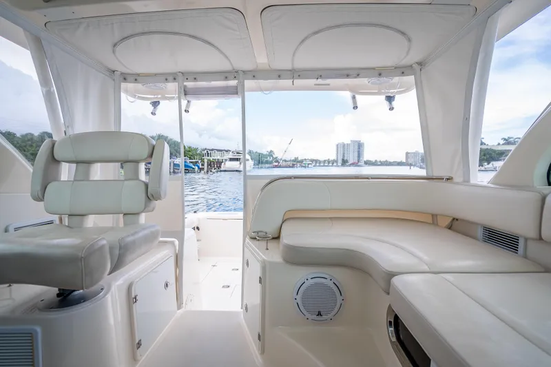 Slide: The Image of 2011 Pursuit OS 345 Offshore boat interior with cream seating and waterfront view. - 50