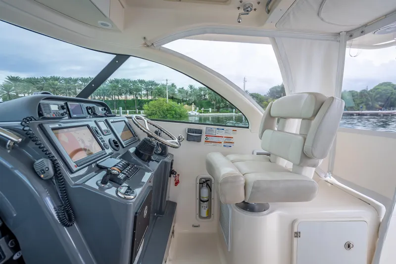 Slide: The Image of 2011 Pursuit OS 345 Offshore boat cockpit with modern navigation equipment and comfortable seating. - 53