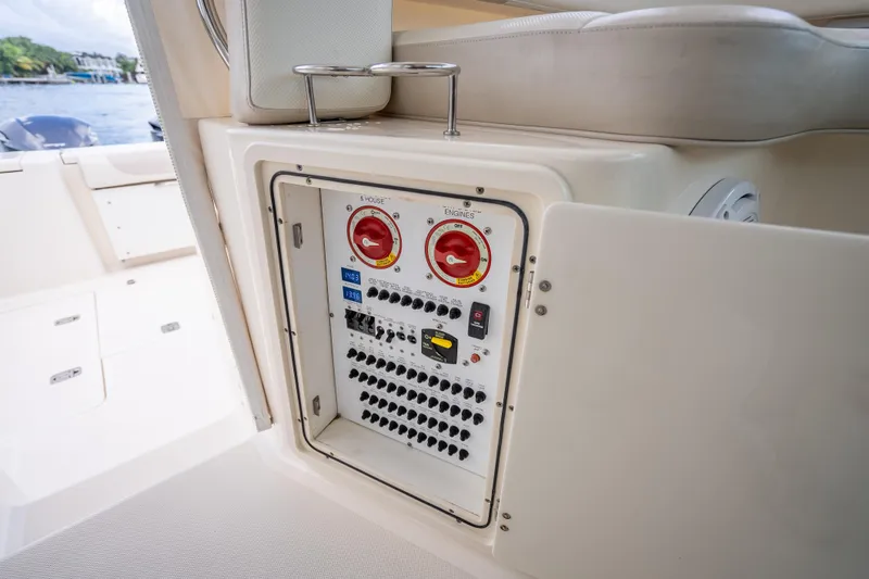 Slide: The Image of 2011 Pursuit OS 345 Offshore boat electrical panel with switches and controls. - 55