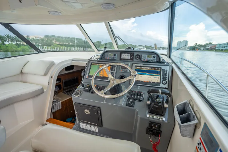 Slide: The Image of Helm of 2011 Pursuit OS 345 Offshore boat with navigation equipment and scenic waterway view. - 59