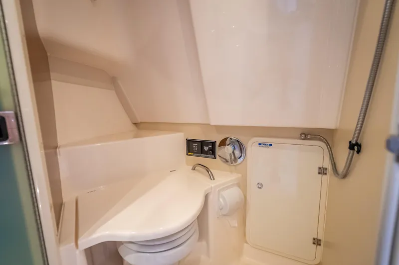 Slide: The Image of 2011 Pursuit OS 345 Offshore boat bathroom with compact design and modern fixtures. - 65